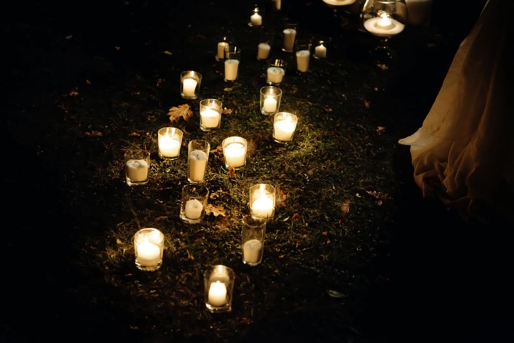 romantic candle light in glass lanterns at luxury wedding ceremony in evening, decor and arrangements