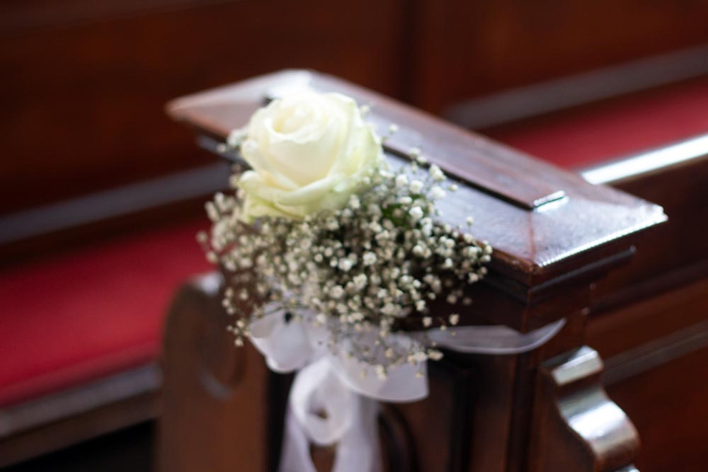 White rose and baby's breath decoration on church pew-wedding or ceremony. High quality photo